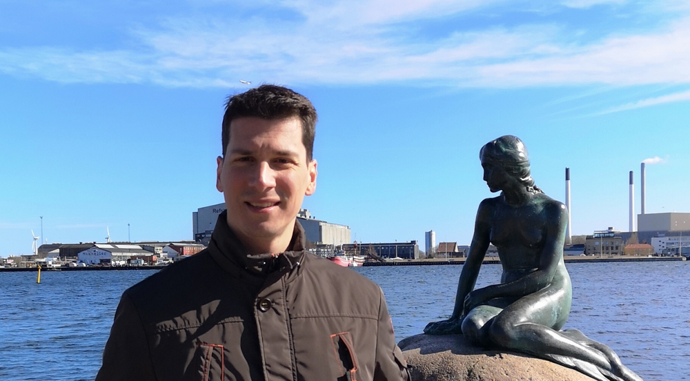 Kostas Tsirigos, pictured in front of the statue of the little mermaid by the waterside in Copenhagen. 